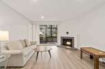 Step into this inviting living space, featuring a cozy fireplace and abundant natural light.