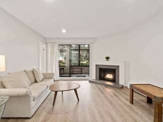 Step into this inviting living space, featuring a cozy fireplace and abundant natural light.
