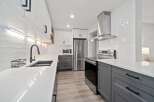 Step into this stunning kitchen, featuring sleek white cabinetry and modern gray accents.