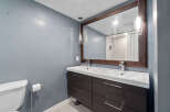 This modern bathroom features a sleek double vanity with ample storage, perfect for a shared space.