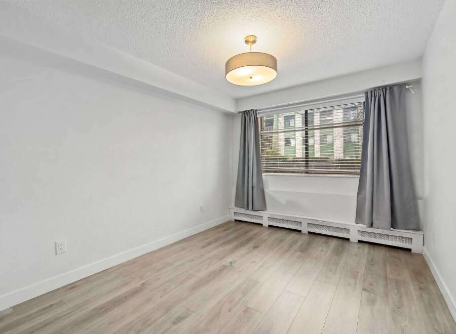 This bright and airy room features a neutral color palette, creating a versatile space ready for your personal touch.