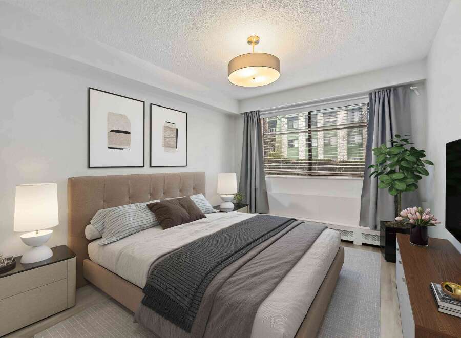 Step into this inviting bedroom, featuring a cozy bed adorned with stylish bedding and pillows.