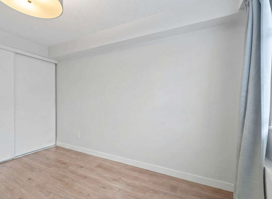 Discover the potential of this blank canvas! This room features a clean, modern design with neutral walls and light wood flooring, perfect for customization.