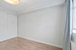 Discover the potential of this blank canvas! This room features a clean, modern design with neutral walls and light wood flooring, perfect for customization.