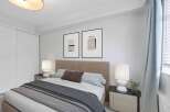 This inviting bedroom features a cozy bed with stylish bedding, perfect for relaxation.