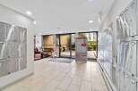 This inviting apartment building entrance features a well-lit hallway with modern mailboxes.