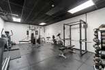 This well-equipped home gym offers a comprehensive workout space.