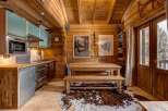 Step into this charming chalet kitchen, a perfect blend of rustic charm and modern convenience.