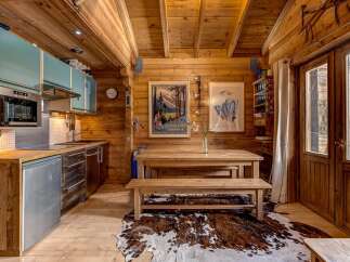 Step into this charming chalet kitchen, a perfect blend of rustic charm and modern convenience.