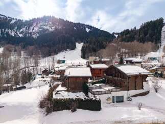 Nestled in a picturesque winter wonderland, this charming property offers a cozy retreat with stunning mountain views.