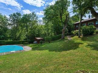 Discover your dream home in this stunning property! Featuring a private pool, lush green lawns, and mature trees, this residence offers a serene and picturesque setting.