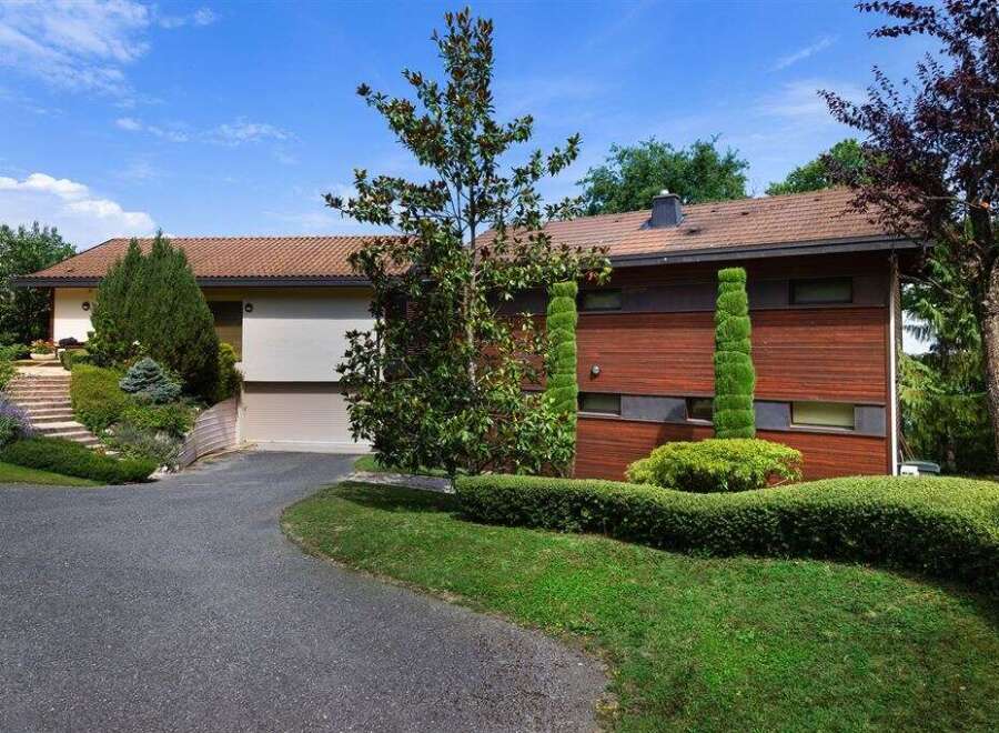 Discover this stunning property featuring a modern design and lush landscaping.