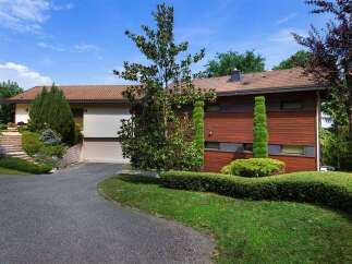 Discover this stunning property featuring a modern design and lush landscaping.
