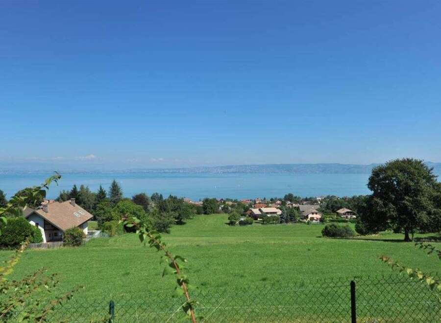 Discover this charming property with a picturesque view of the serene lake and distant mountains.