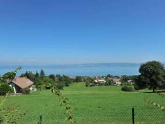 Discover this charming property with a picturesque view of the serene lake and distant mountains.