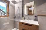 This modern bathroom features a sleek design with a walk-in shower and a stylish vanity.