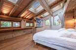 Experience luxury living in this stunning bedroom featuring a unique wooden design.