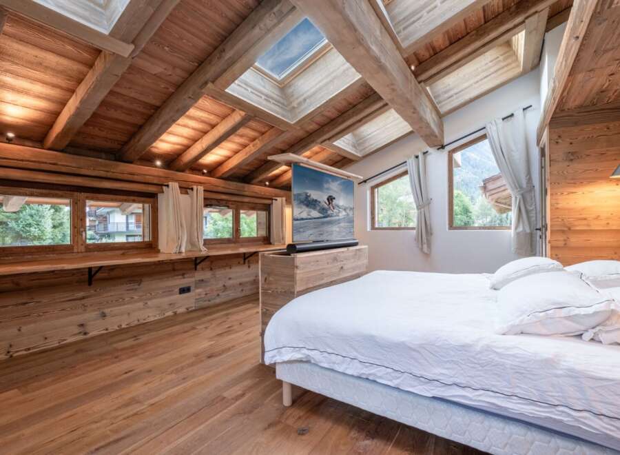 Experience luxury living in this stunning bedroom featuring a unique wooden design.