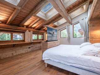 Experience luxury living in this stunning bedroom featuring a unique wooden design.