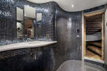 This unique bathroom showcases a stunning mosaic tile design, creating a luxurious and modern aesthetic.