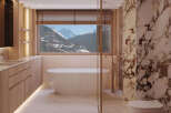 Indulge in luxury with this stunning bathroom featuring a freestanding tub and breathtaking mountain views.