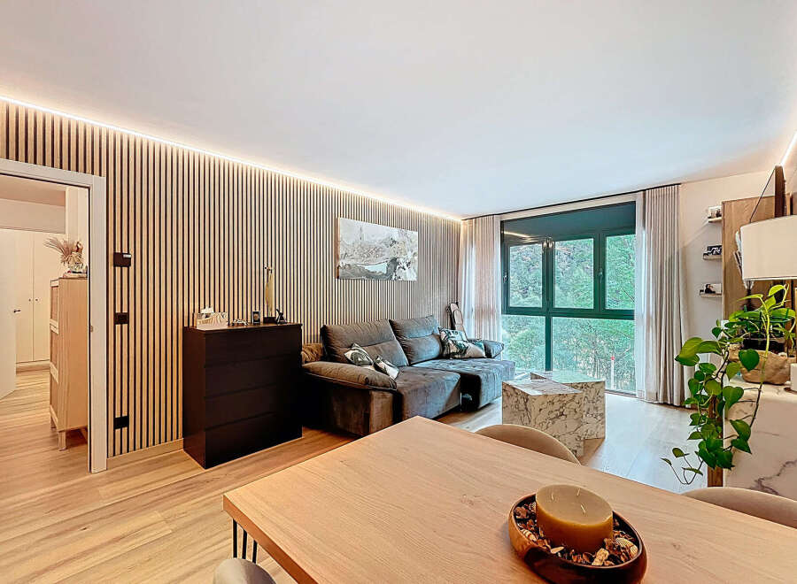 Experience modern living in this stylish apartment featuring a cozy living room with a comfortable sofa and a marble coffee table.