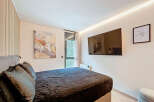 This modern bedroom features a sleek design with a comfortable bed and stylish decor.