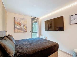This modern bedroom features a sleek design with a comfortable bed and stylish decor.