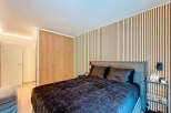 This stunning bedroom boasts a modern design with a focus on natural elements.