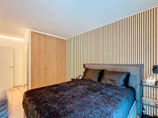 This stunning bedroom boasts a modern design with a focus on natural elements.