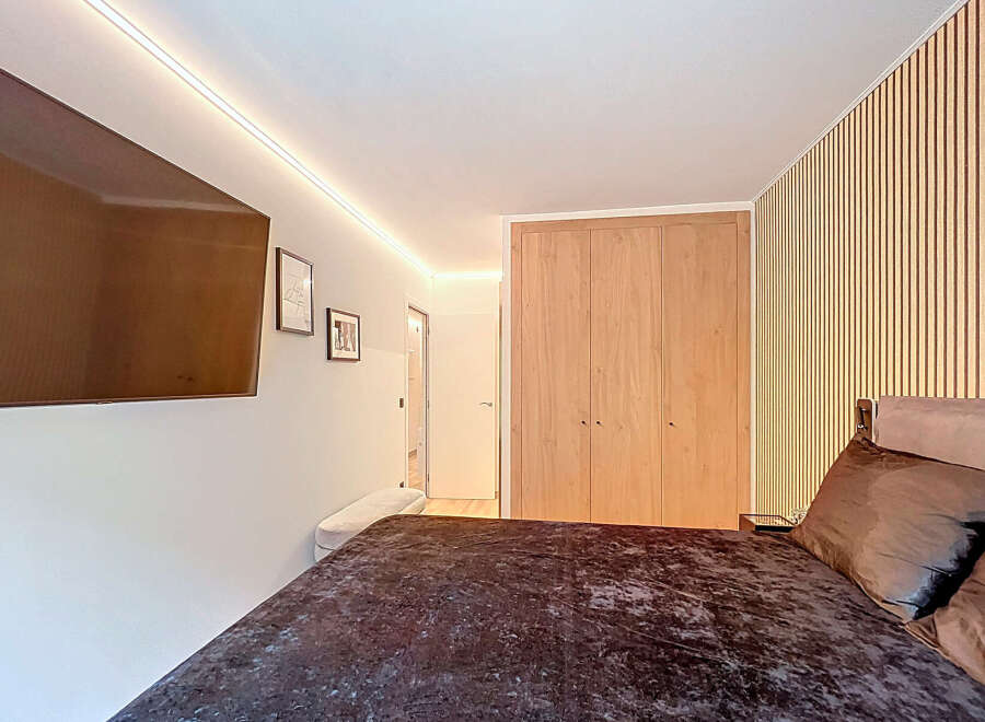 Step into a modern bedroom featuring a sleek design and inviting ambiance.
