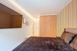 Step into a modern bedroom featuring a sleek design and inviting ambiance.
