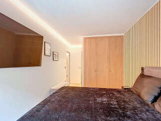 Step into a modern bedroom featuring a sleek design and inviting ambiance.