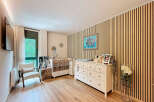 This charming nursery offers a serene and stylish space for your little one.