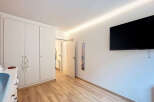 This bright and airy bedroom features a large built-in wardrobe, providing ample storage space.