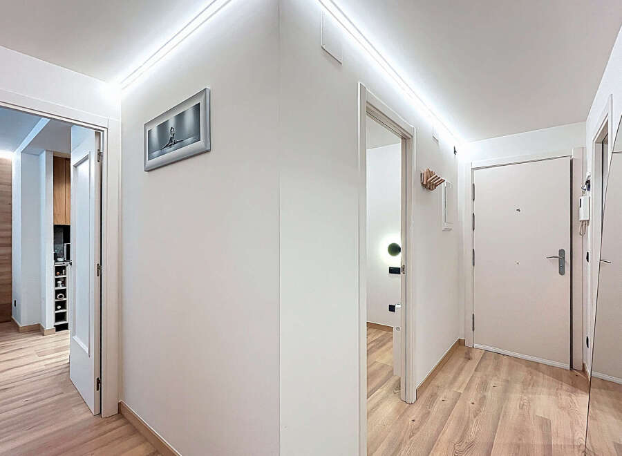 This modern hallway features a sleek design with clean lines and bright lighting.