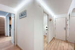 This modern hallway features a sleek design with clean lines and bright lighting.