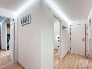 This modern hallway features a sleek design with clean lines and bright lighting.