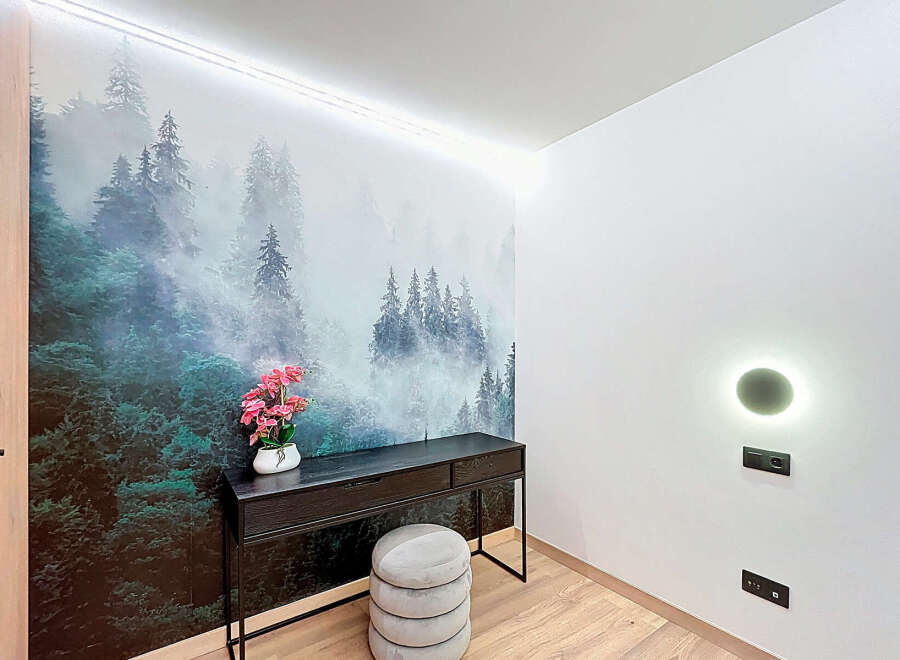 This stunning property features a unique forest-themed accent wall, creating a serene and inviting atmosphere.