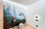 This stunning property features a unique forest-themed accent wall, creating a serene and inviting atmosphere.