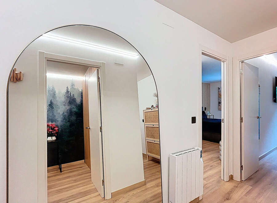Step into this stylish entryway, featuring a stunning arched mirror that amplifies natural light and creates a sense of spaciousness.