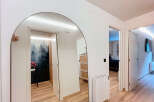 Step into this stylish entryway, featuring a stunning arched mirror that amplifies natural light and creates a sense of spaciousness.
