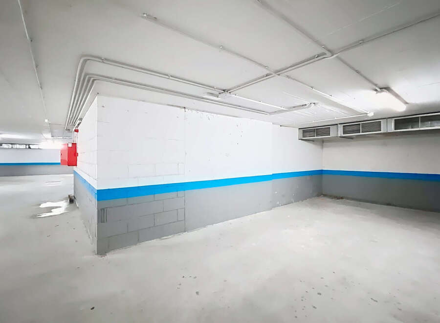 Explore this spacious and well-lit parking garage, perfect for secure vehicle storage.