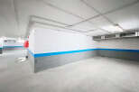 Explore this spacious and well-lit parking garage, perfect for secure vehicle storage.