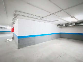 Explore this spacious and well-lit parking garage, perfect for secure vehicle storage.