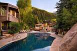 Escape to luxury at this stunning property featuring a beautiful outdoor pool and a backdrop of lush mountains.
