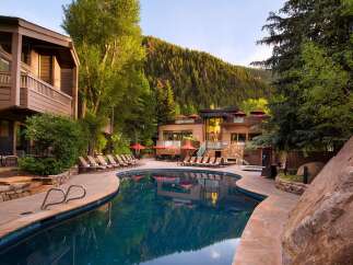 Escape to luxury at this stunning property featuring a beautiful outdoor pool and a backdrop of lush mountains.