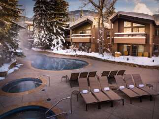 Experience luxury and relaxation at this stunning property featuring a heated outdoor pool and hot tubs, perfect for unwinding after a day of skiing or exploring.