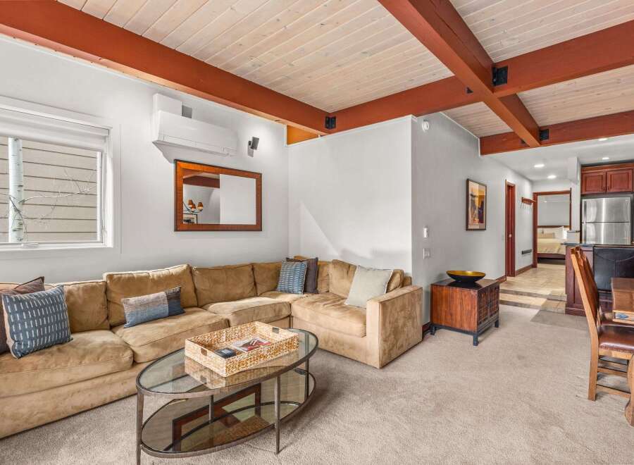 This stunning property boasts a spacious living area with a comfortable sectional sofa, perfect for relaxing and entertaining.