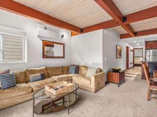 This stunning property boasts a spacious living area with a comfortable sectional sofa, perfect for relaxing and entertaining.